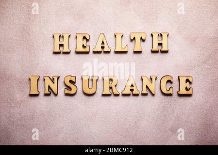 Health insurance text on a colored paper. Stock Photo