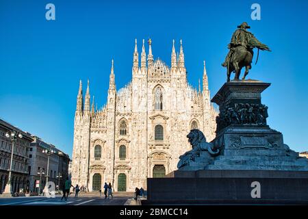 Milan, Italy May 8, 2020: The golden sunshine is reflecting on the front of the magnificent Duomo di Milano or Milan Cathedral after Italy eases coron Stock Photo