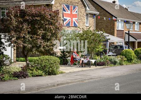 Ackworth, UK - May 08, 2020: A family come out from houses to the street to celebrate 75th anniversary VE Day - Victory in Europe in small village in Stock Photo