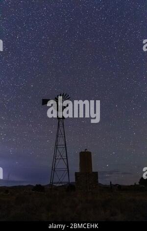 Windmill against vast starry sky above City of Rocks State Park, located between Silver City and Deming in the Chihuahuan Desert, New Mexico, USA Stock Photo