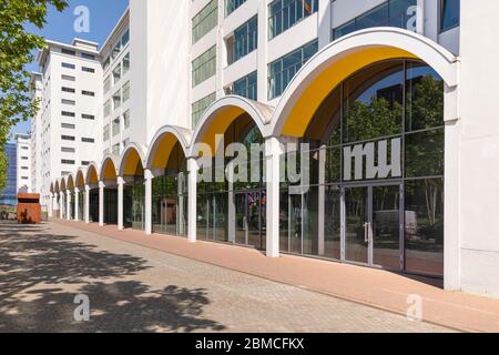 Eindhoven, The Netherlands, May 7th 2020. Strijp S district with the old white Philips buildings and the facade of Mu artspace seen from the Torenalle Stock Photo