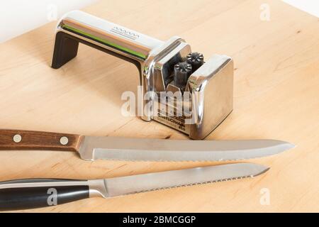 Knife sharpener with serrated knives still life, USA Stock Photo