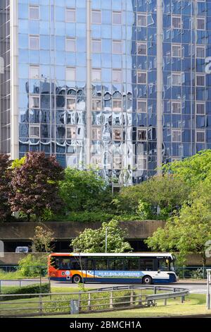 A Stagecoach bus drives past Churchill Place highrise flats in Basingstoke Town centre - theme: urban, public transport, reopening covid-19 lockdown Stock Photo