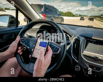 Texting and driving on highway in daytime Stock Photo