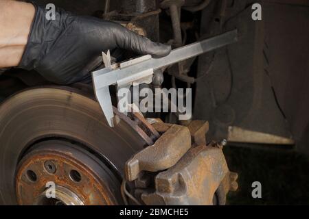 Brake replacement. Assessment of technical condition, thickness measurement of mechanical calipers. Stock Photo