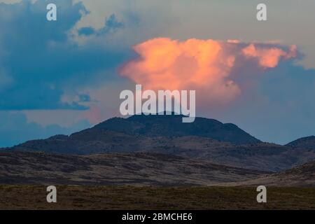 Clouds lit by setting sun viewed from City of Rocks State Park, located between Silver City and Deming in the Chihuahuan Desert, New Mexico, USA Stock Photo