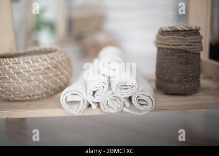 Clean towels with soap dispenser on shelf in bathroom. Close up. Stock Photo