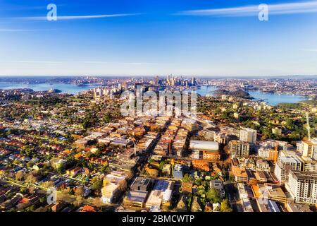 Lower north shore green leafy residential suburbs around Sydney harbour if elevated aerial view of city skyline under blue sky. Stock Photo