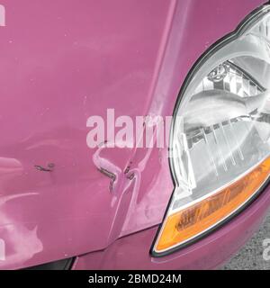 Damaged bodywork. Dents and scratch marks on a car's hood. Close-up. Stock Photo