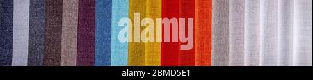 Rainbow clothes background. Pile of bright folded clothes Stock Photo
