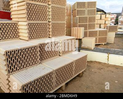 Ceramic construction blocks arranged in stack for house construction Stock Photo