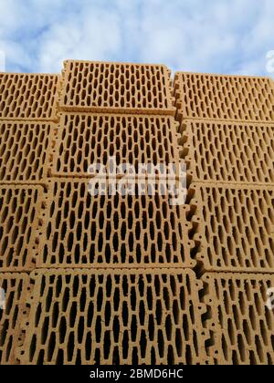 Many ceramic building blocks arranged in the stack in construction site Stock Photo