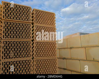 Many ceramic building blocks arranged in the stack in construction site Stock Photo
