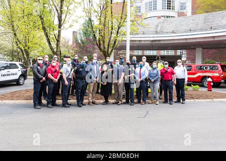 Hospital workers standing with Concord Police and Concord Fire outside of Emerson Hospital after the Appreciation Parade thanking healthcare workers. Stock Photo