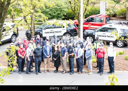 Hospital workers standing with Concord Police and Concord Fire outside of Emerson Hospital after the Appreciation Parade thanking healthcare workers. Stock Photo