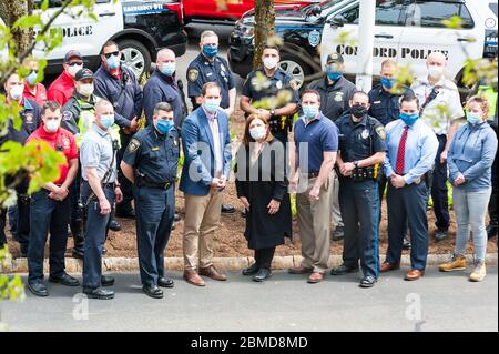 Hospital workers standing with Concord Police and Concord Fire outside of Emerson Hospital after the Appreciation Parade thanking healthcare workers. Stock Photo