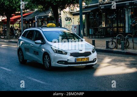 Tel Aviv Israel November 14, 2019 View of traditional Israeli taxi rolling in the streets of Tel Aviv in the afternoon Stock Photo