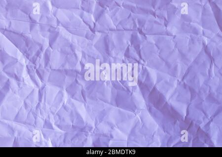 texture of a crumpled paper in lilac color. Empty background. Stock Photo