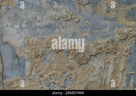 Background of a weathered wall where the plaster falls off Stock Photo