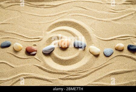 Zen garden with pebbles on sand background Stock Photo