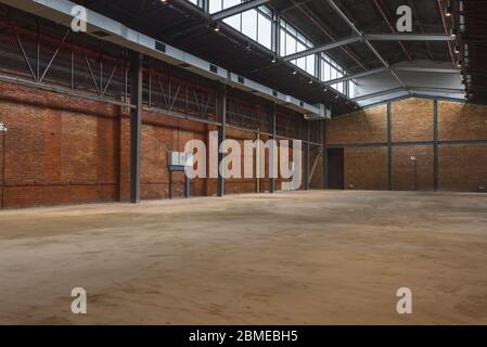 Unmanned, industrial style old warehouse building space. Stock Photo