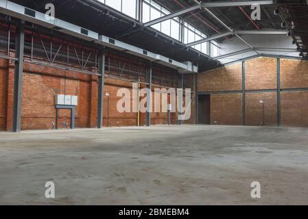 Unmanned, industrial style old warehouse building space. Stock Photo