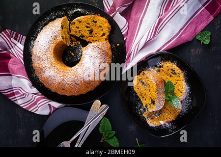 Pumpkin cake with chocolate chips for autumn fall dinner. Vegetarian food. Top view, overhead Stock Photo