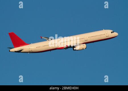 Airbus A321 airliner jet plane airplane aircraft flying in flight airborne blue sky air travel civil aviation sunset unmarked no livery generic Stock Photo