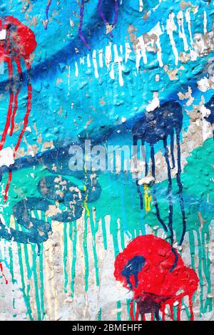Closeup of colorful messy painted urban wall texture. Modern pattern for wallpaper design. Creative urban city background. Abstract open composition. Stock Photo