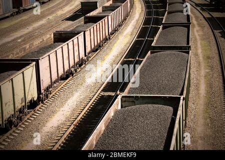 rail cars loaded with coal, a train transports coal. Stock Photo
