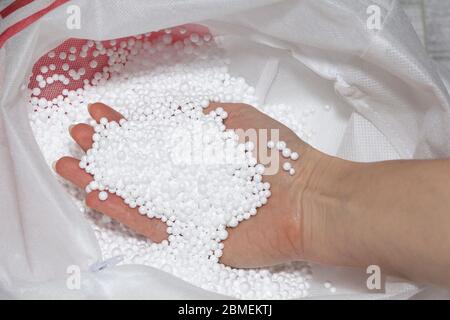 Round Styrofoam balls in my hands, the texture for the background. Environmental protection Stock Photo