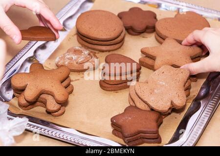 Children's hands reach for freshly baked liver. Celebration of the holiday and the concept of cooking Stock Photo