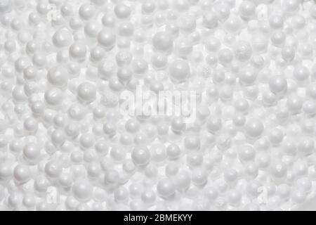 Round Styrofoam balls in my hands, the texture for the background. Environmental protection. Stock Photo