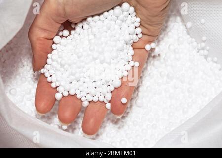 Round Styrofoam balls in my hands, the texture for the background. Environmental protection. Stock Photo