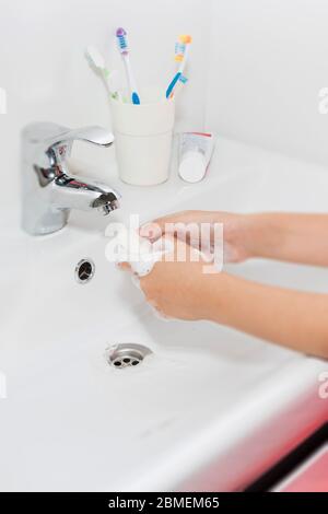 Hygiene concept. Washing hands with soap under the faucet with water