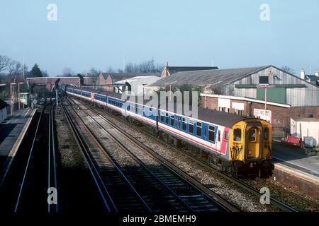 A train formed of three Class 411 4-Cep electric multiple units numbers 1563, 1606 and 1590 arriving at Paddock Wood station with a Network SouthEast service. Stock Photo