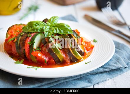 Homemade ratatouille made with sliced vegetables: zucchini, tomatoes and eggplant. Stock Photo