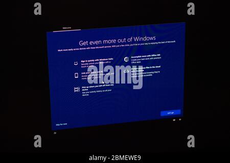 London, United Kingdom - Mar 28, 2020: Man hand POV touching the touchscreen of a modern Microsoft Windows PC computer during the update of the OS operating system Stock Photo
