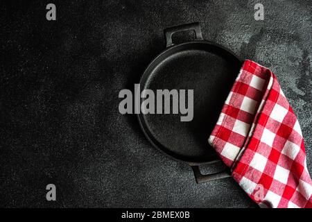 Rustic table setting with metal pan in vintage style and red towel on stone background with copy space Stock Photo