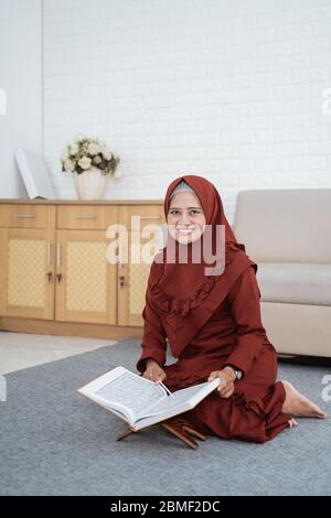 Muslim hijab woman learning of Quran at spare time in the home Stock Photo