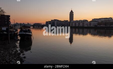 London, England, UK - February 19, 2013: The sun sets behind new build apartment buildings at Imperial Wharf in west London. Stock Photo