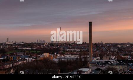 London, England, UK - January 2, 2013: The sun rises over the suburban streets of Tooting, South London, with the city skyline in the distance. Stock Photo