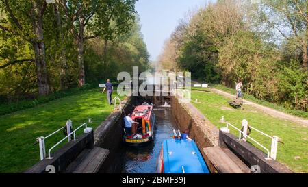 Newbury, England - April 22, 2011: Narrow boats pass through Hamstead Lock on the Kennet and Avon Canal. Stock Photo