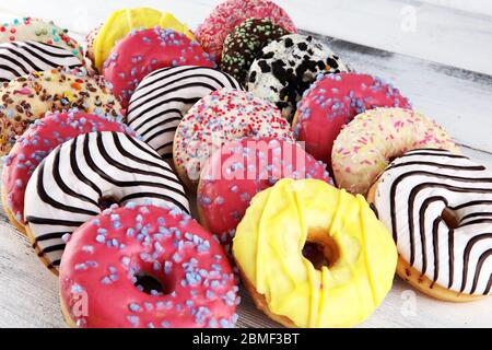 assorted donuts with chocolate frosted, pink glazed and sprinkles donuts. Stock Photo
