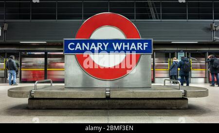 London, England, UK - March 10, 2020: Commuters queue at platform doors as a Jubilee Line train arrives at Canary Wharf tube station. Stock Photo