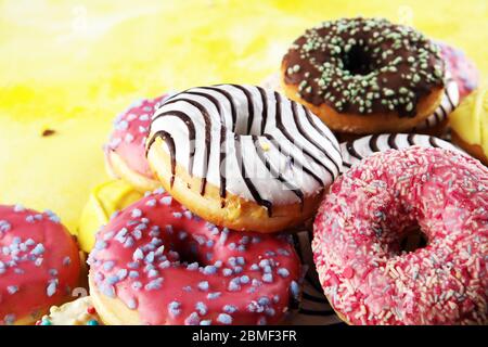 assorted donuts with chocolate frosted, pink glazed and sprinkles donuts. Stock Photo