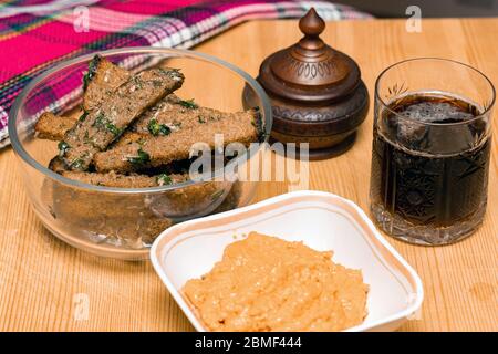 Beer snack fried croutons with cheese sauce on wooden board. Rye bread croutons with garlic, oil and salt. Drinks and food. Stock Photo