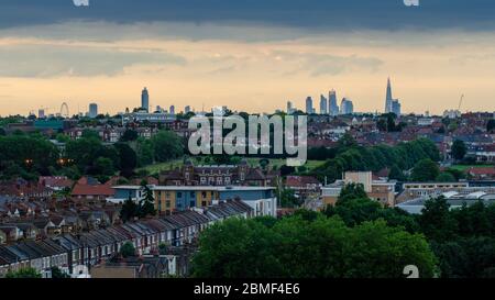 London, England, UK - June 24, 2013: Skyscrapers of the City of London rise on the distant skyline behind the suburban streets of Tooting in South Lon Stock Photo