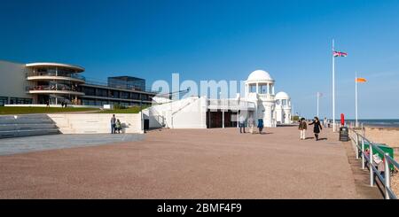 Bexhill on Sea, England, UK - June 8, 2013: People walk on the promenade outside the art deco De La Warr Pavilion on the seafront of Bexhill in East S Stock Photo