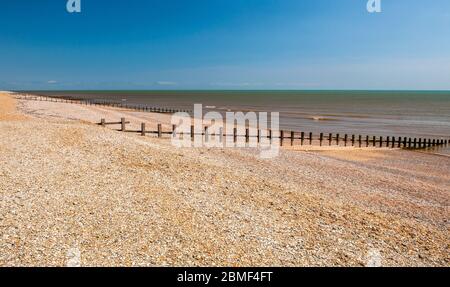 Wooden groynes protect against coastal erosion at Broomhill Sands and Camber Sands beaches in East Sussex. Stock Photo